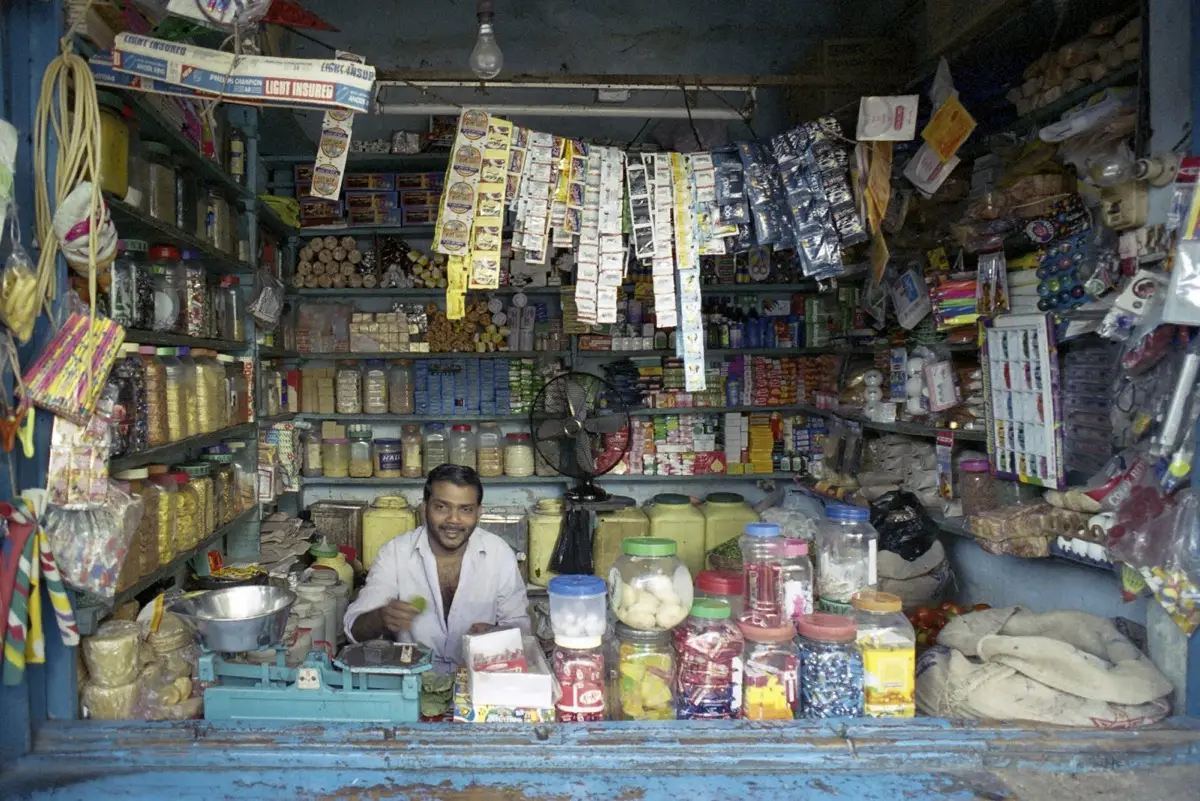 A shopkeeper behind a busy counter